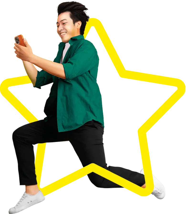 A man jumping in joy while using his mobile phone on the Asda Mobile network.